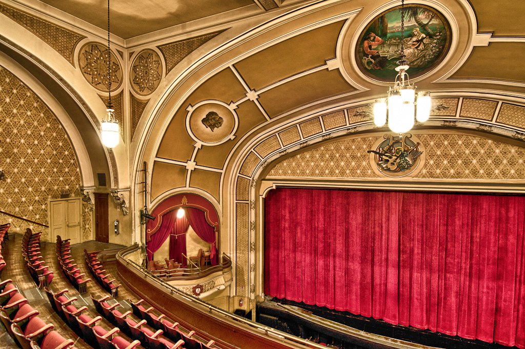 Art Deco Theatre Chicago with arched gold ceiling and red velvet details